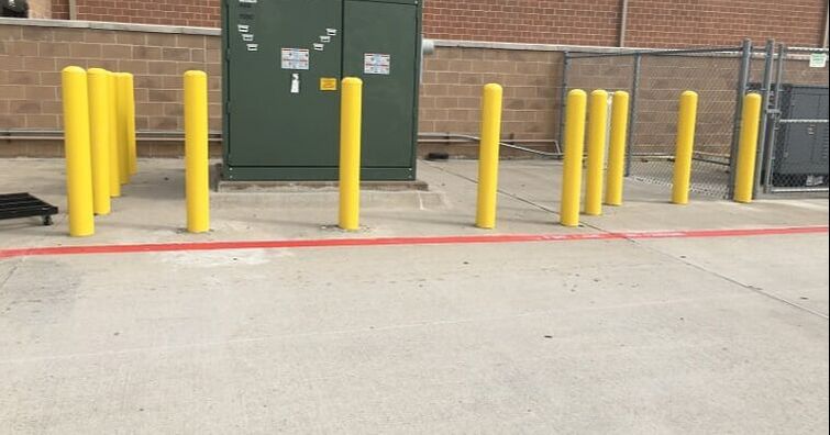 Multiple yellow bollards installed in Grapevine, Texas parking lot