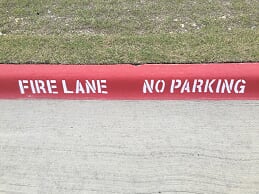 Parking lot striping and fire lane striping on curb in Grapevine, TX