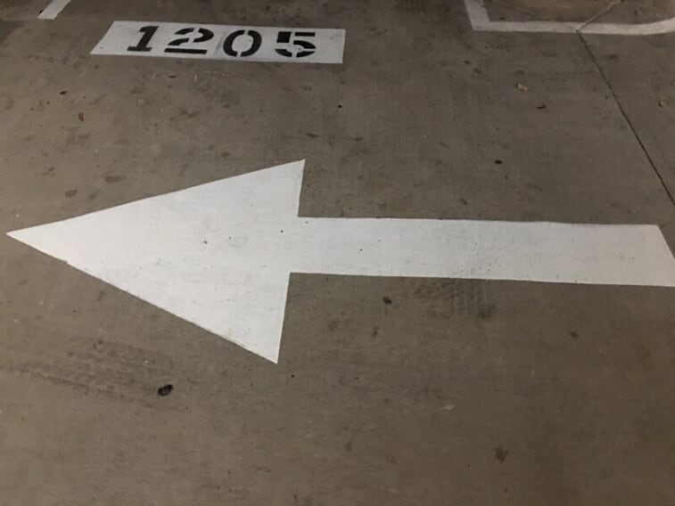 Directional arrow with number stencil painted in your parking lot in Grapevine, Texas